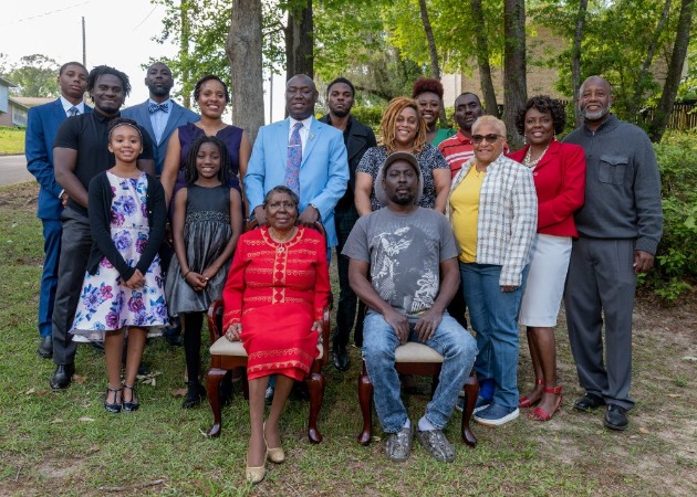 Genae Angelique Crump stands behind her mother-in-law as the family poses for a photo.